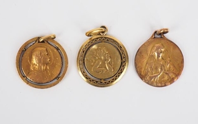Three different yellow gold medals.