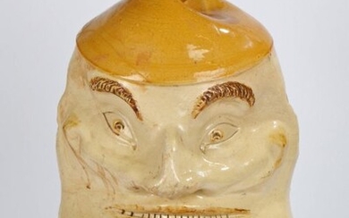 Unusual and amusing 19th Century cider jug, of very large proportions, the leaning hat containing