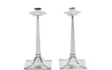 A pair of Edwardian Arts and Crafts silver candlesticks
