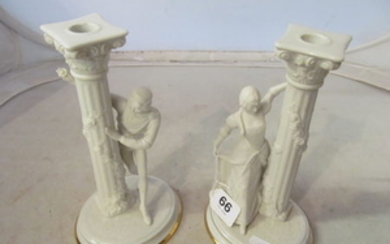 A pair of Franklin Mint candlesticks with male and female.