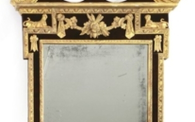 A George III mahogany and parcel gilt wall mirror, the boldly scrolled pediment above a frieze with ...