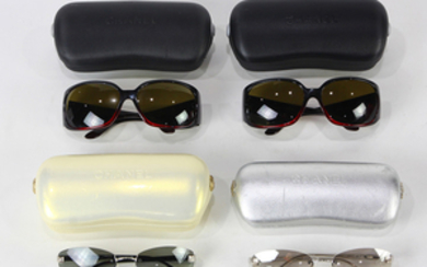 Chanel sunglasses group, one having red frames accented with rhinestones, two having black frames, and the last with clea...