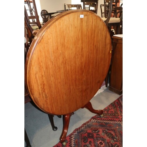 A 19th century mahogany circular tilt top dining table, on t...