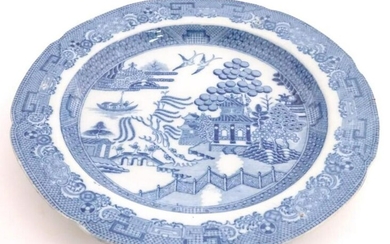 A 19thC blue and white plate decorated in the Willow