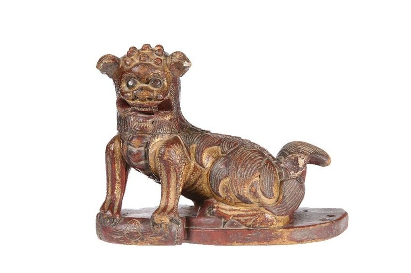 A CHINESE CARVED WOODEN MODEL OF A FOO DOG, gilded and