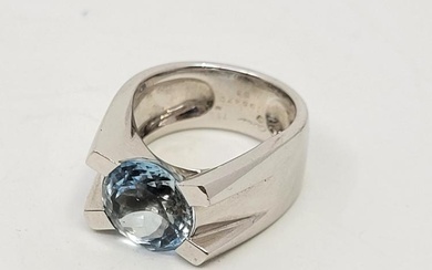 A Cartier 18ct. white gold and aquamarine ring, tension set...