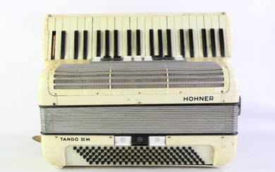 A Cased Hohner Tango III Piano Accordian (Some Losses)