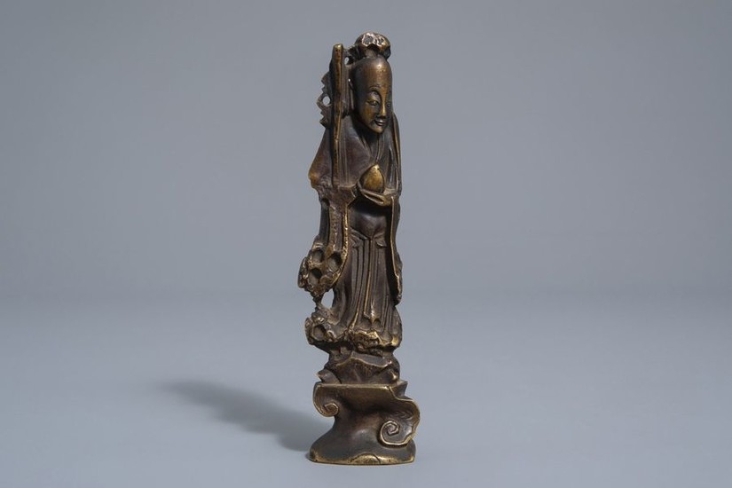 A Chinese bronze scroll weight modelled as the...