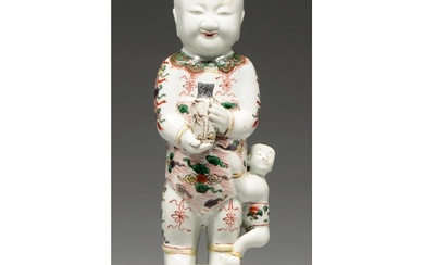 A Chinese famille verte of a boy, Kangxi period, holding a v...
