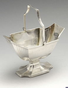 A George III silver swing-handled sugar basket of pedestal form.