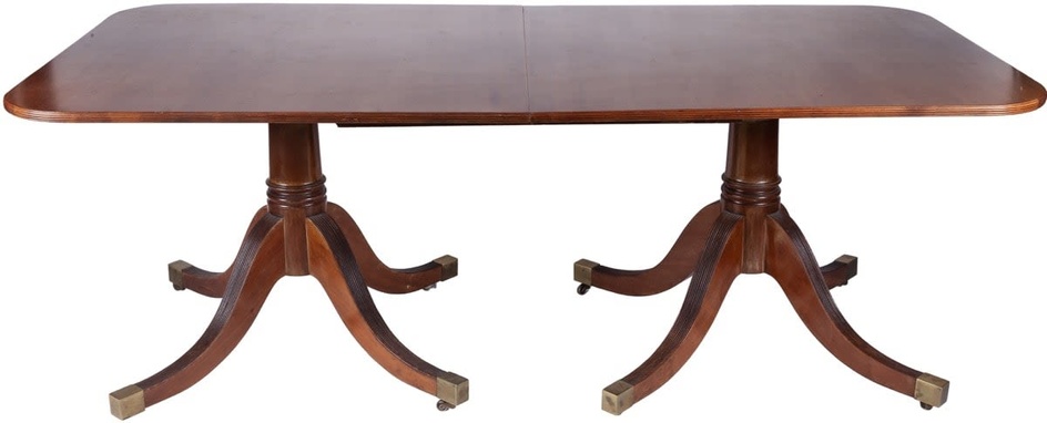 A George III style mahogany extending dining table. One...