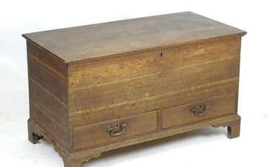 A Georgian oak mule chest with a moulded lid above two