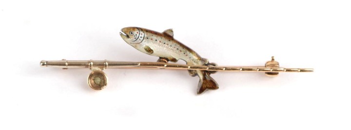 A Novelty Brooch, depicting a trout behind a fishing rod,...