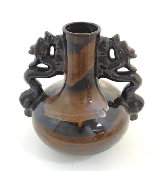 A Oriental twin handled bottle vase with stylised