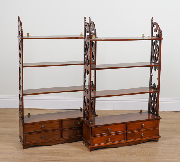 A PAIR OF GEORGE III STYLE MAHOGANY FOUR TIER SHELVES EACH WITH FOUR DRAWER BASE AND FRET CARVED SIDES (2)