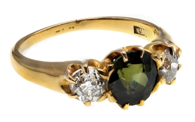 A Peridot and Diamond Ring Three stone ring with a central peridot flanked by two diamonds, set...