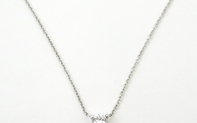 A Platinum necklace set with diamond pendant. The diamond a...