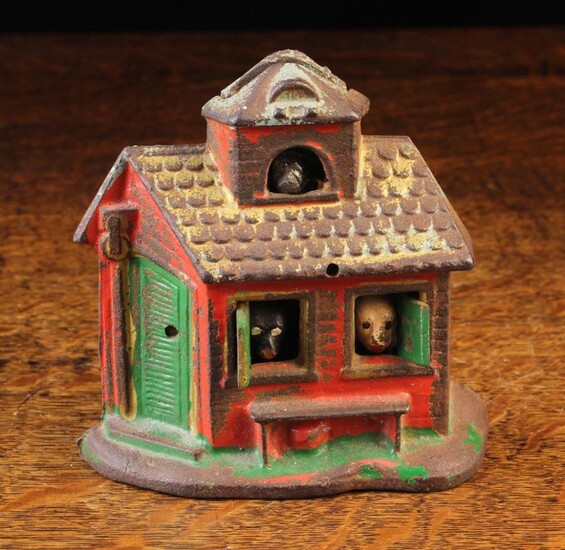 A Rare Painted Cast Iron Money bank in the form of a lodge with coin slot to the dormer above an arc