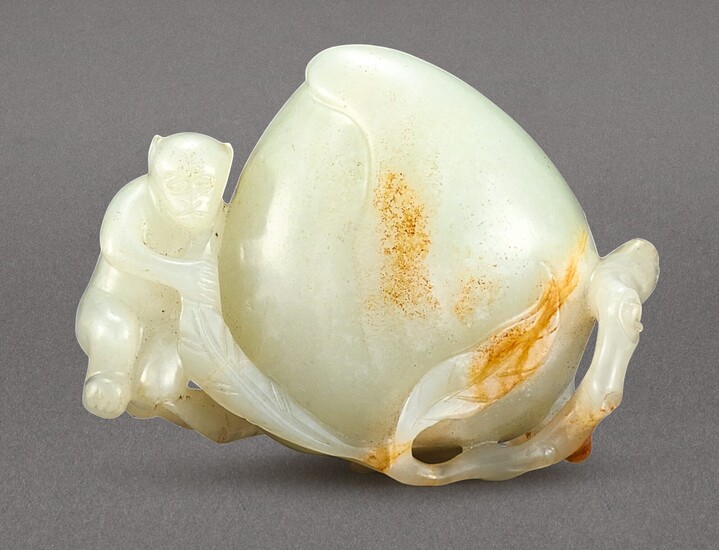 A WHITE AND RUSSET JADE 'MONKEY AND PEACH' GROUP QING DYNASTY, 18TH – 19TH CENTURY
