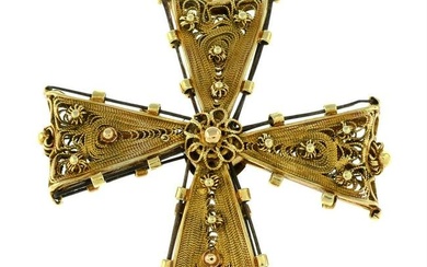 A cannetille cross pendant.