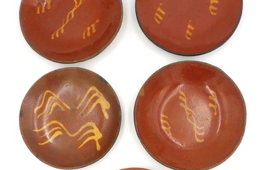 A collection of (5) redware yellow slip glazed bowls.