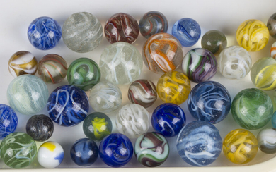 A collection of late 19th and 20th century glass marbles and two modern wooden solitaire boards.