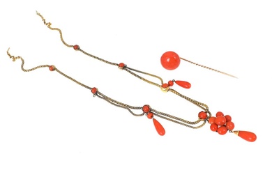 A coral jewelry set comprising a pin set with a cabochon coral...