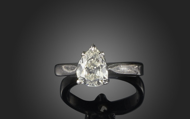 A diamond solitaire ring, claw-set with a pear-shaped diamond weighing approximately 0.80 carats