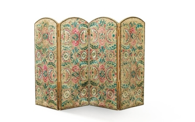 A four-panel screen upholstered in embroidered floral fabric