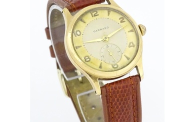 A gentlemans 9ct gold cased wristwatch the dial signed Garra...