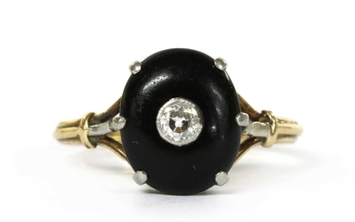 A gold diamond and onyx ring