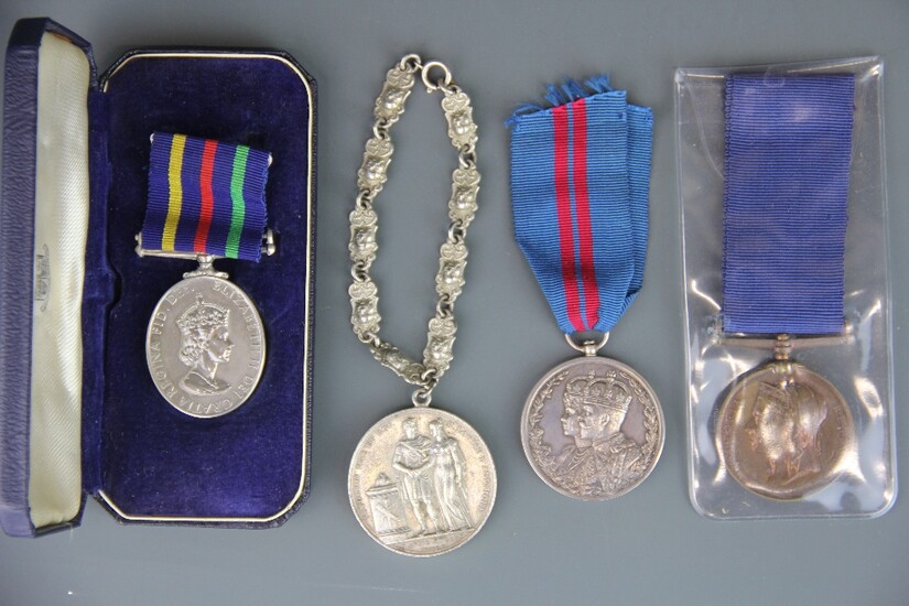 A group of four mixed medals.