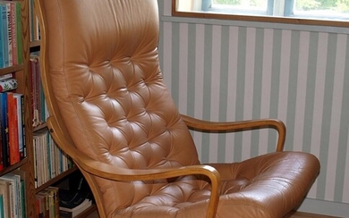 A high back swivel chair upholstered with leather. Second half of the 20th century. No meassures.