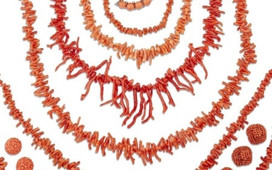 A large group of coral jewellery, including: a graduated waisted carved coral necklace with graduated coral bead spacers; six coral twig or branch necklaces; a coral bead two row necklace with marcasite clasp; a carved coral brooch depicting an...