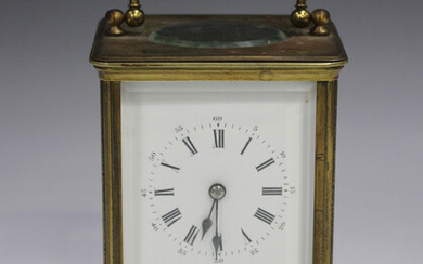 A late 19th/early 20th century brass corniche cased carriage clock with eight day movement striking