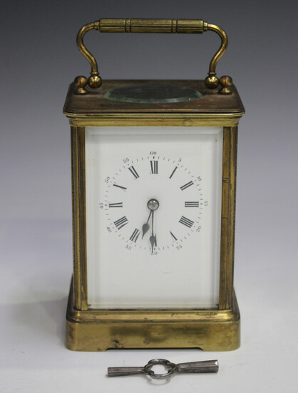 A late 19th/early 20th century brass corniche cased carriage clock with eight day movement striking