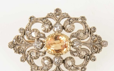 A late Victorian diamond brooch with golden yellow stone to centre