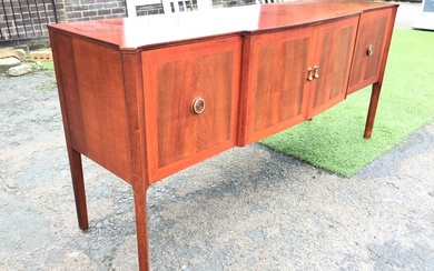 A mid-century mahogany sideboard, the shaped top with canted corners...