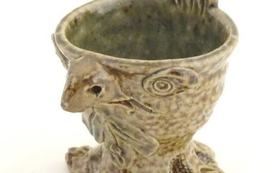 A novelty stoneware egg cup modelled in the style of a