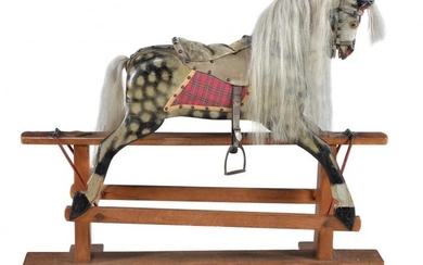 A painted wood and composition rocking horse