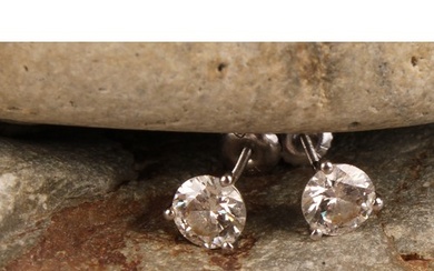 A pair of 14ct white gold diamond stud earring, each diamond...
