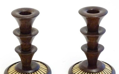 A pair of 20thC treen candlesticks with stepped columns