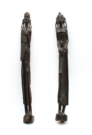 A pair of African carved ebony figures of water carriers