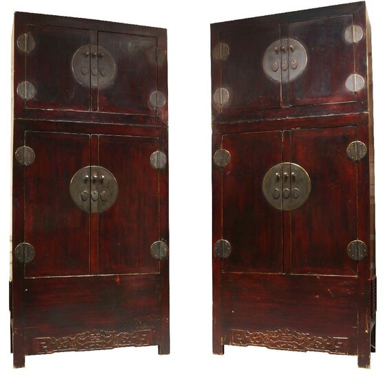 A pair of Chinese lacquered softwood cabinets, late Qing dynasty, each with hat box above pair of cupboard doors and carved archaistic frieze, 236 x 108cm (2)