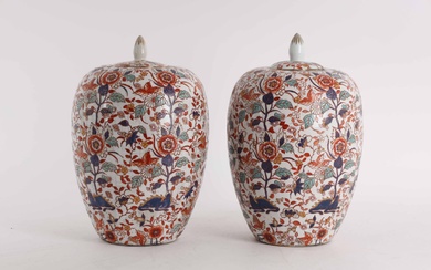 A pair of Chinese porcelain lidded vases, decorated in colors with flowers, leaves and animals.
