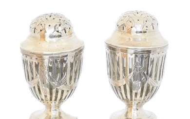 A pair of George III silver and clear glass casters