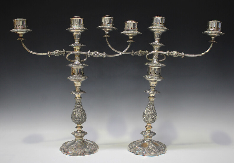 A pair of mid-19th century Sheffield plate three-light twin scroll branch candelabra, each with pier