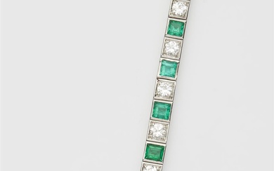 A platinum diamond and emerald tennis bracelet.
