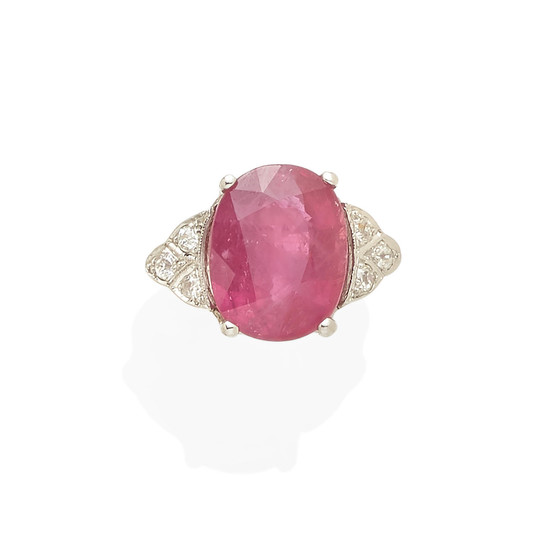 A platinum, pink sapphire, and diamond ring