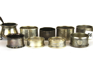 A quantity of hallmarked silver napkin rings and two cruet items.